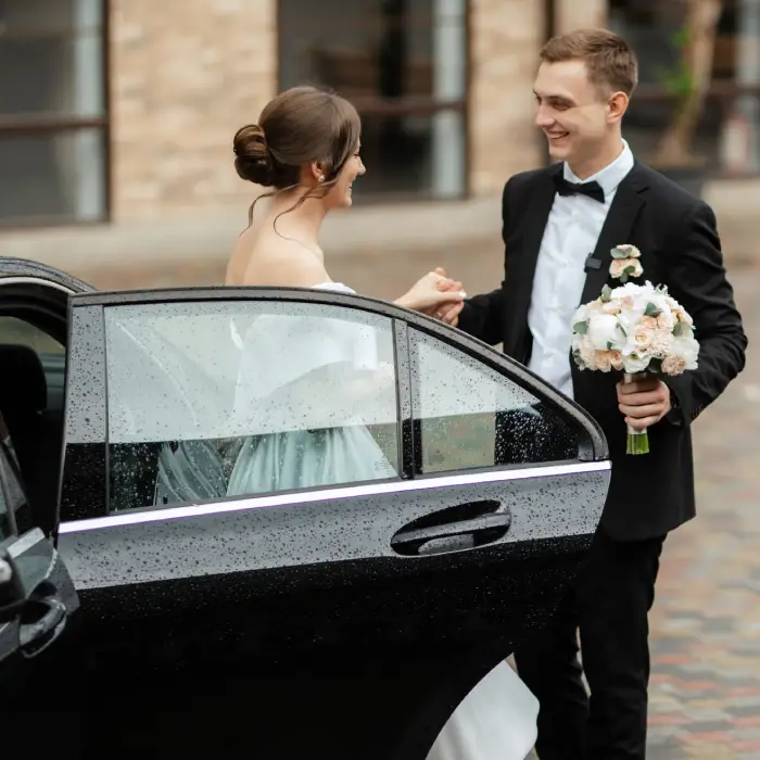 Bride stepping out of a wedding limousine in Boston